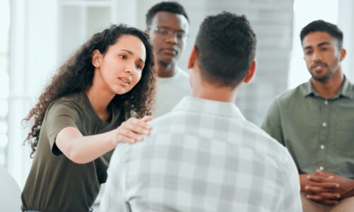 A leader facilitating a conflict resolution meeting with team members